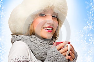 Young girl with mug on winter background