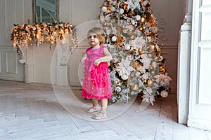 Young girl near a Christmas tree