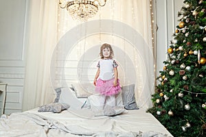 Young girl near a Christmas tree