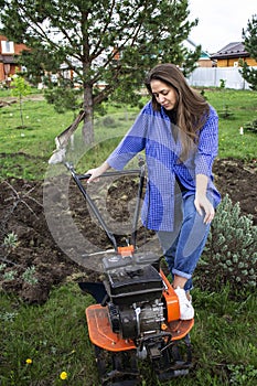 Young girl near the motor-block plow land