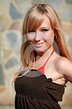 Young girl near stone wall