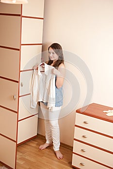 Young girl near wardrobe