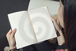 Young girl open the pages of the book empty. text for banner lifestyle and school.