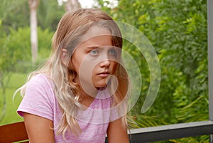 Young girl outside with a sad expression