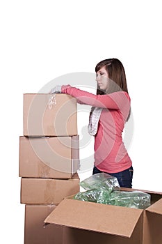 Young girl packing up and moving - isolated
