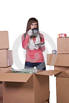 Young girl packing up and moving - isolated