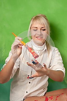 Young girl painting her hand