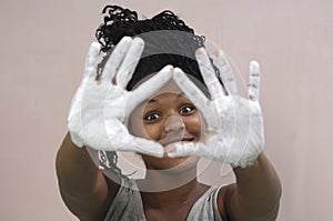 Young girl painting and soiling, african girl