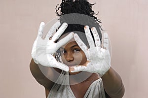 Young girl painting and soiling, african girl