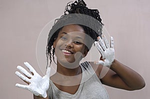 Young girl painting and soiling, african girl