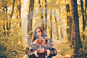 Young girl in park on sunny autumn day. Autumn woman having fun at the park and smiling. Autumn landscape.