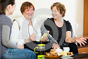 Young girl paying visit to senior grandmothers