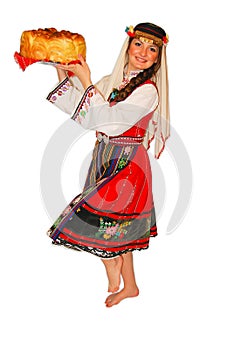 Young girl peasant with traditional Bulgarian folklore costume and sourdough bread in hand portrait isolated