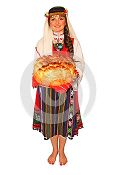 Young girl peasant with traditional Bulgarian folklore costume and sourdough bread in hand portrait isolated