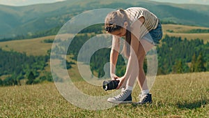 Young girl photographer filming movie