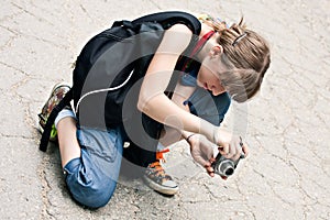 Young girl photographer taking photo