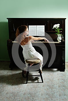 Young girl and piano at home