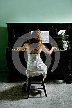 Young girl and piano at home