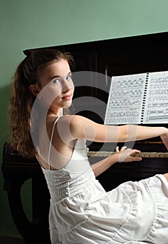 Young girl and piano at home