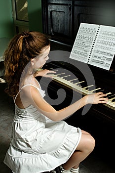 Young girl and piano at home