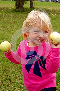 Young girl picking apples