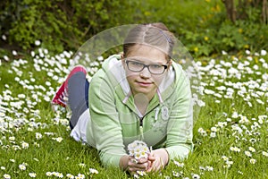 Young girl picking daisies