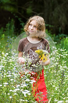 Young girl picking wild flowers