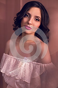 Young girl in pink dress in the studio