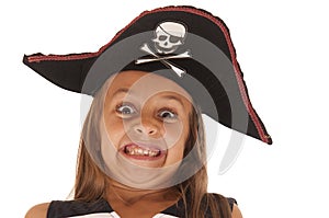 Young girl in pirate's hat pulling a very funny face