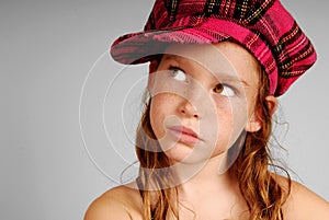 Young girl in plaid cap