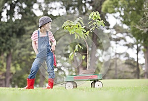 Young girl planting tree in park eco-aware