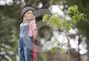 Young girl planting tree in park eco-aware