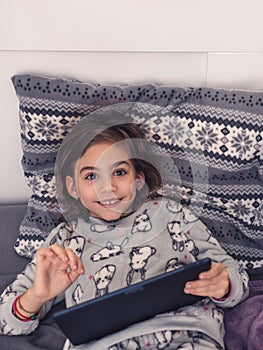 Young girl play on the tablet.