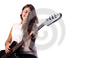 Young girl playing on a bass guitar