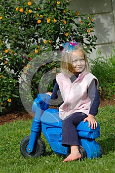 Young girl playing on bike