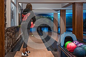 Young girl playing bowling during winter