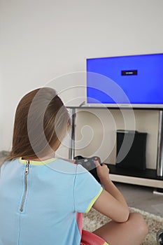 Young girl playing in front of the TV