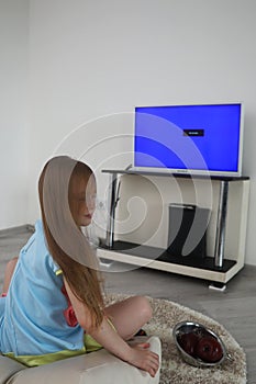 Young girl playing in front of the TV