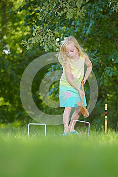 Young girl playing croquet