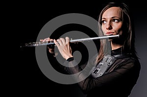 A young girl playing the flute