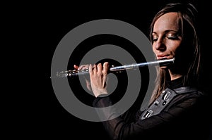 A young girl playing the flute