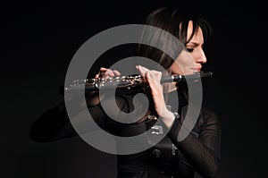 A young girl playing the flute