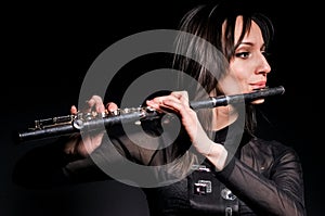 A young girl playing the flute