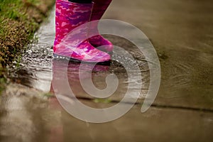 A young girl is playing in the much needed California rain.