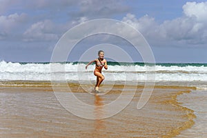 Young girl playing in ocean coast