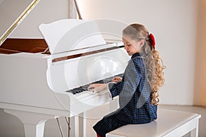 A young girl is playing the piano.