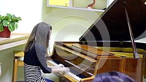 Young girl playing a piano