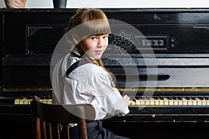 Young girl playing piano indoor