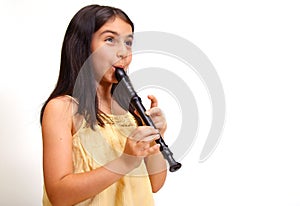 Young girl playing recorder photo