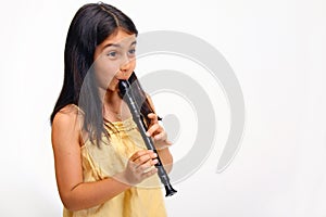 Young girl playing recorder